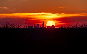 Preview wallpaper buildings, city, silhouettes, sun, sunset, dark