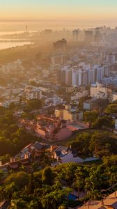 Preview wallpaper buildings, city, trees, sea, dawn, aerial view