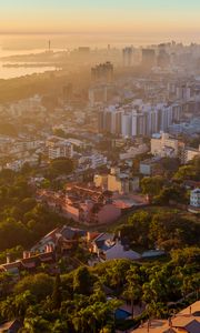 Preview wallpaper buildings, city, trees, sea, dawn, aerial view