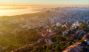 Preview wallpaper buildings, city, trees, sea, dawn, aerial view