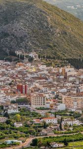 Preview wallpaper buildings, city, valley, mountain, trees