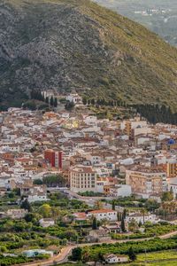 Preview wallpaper buildings, city, valley, mountain, trees