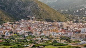 Preview wallpaper buildings, city, valley, mountain, trees