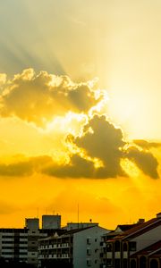 Preview wallpaper buildings, clouds, sunlight, rays, city