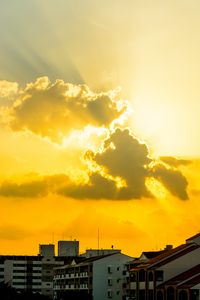 Preview wallpaper buildings, clouds, sunlight, rays, city