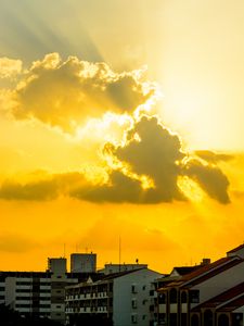 Preview wallpaper buildings, clouds, sunlight, rays, city