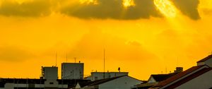Preview wallpaper buildings, clouds, sunlight, rays, city