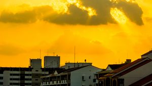 Preview wallpaper buildings, clouds, sunlight, rays, city