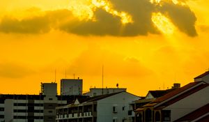 Preview wallpaper buildings, clouds, sunlight, rays, city