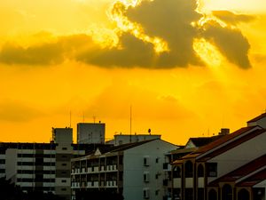 Preview wallpaper buildings, clouds, sunlight, rays, city