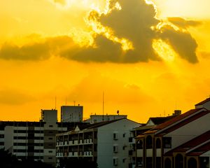 Preview wallpaper buildings, clouds, sunlight, rays, city