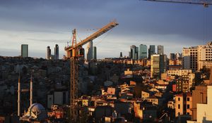 Preview wallpaper buildings, construction crane, city, evening