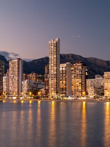Preview wallpaper buildings, houses, lights, sea, reflection, twilight, city