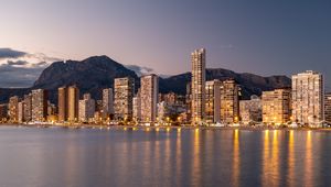 Preview wallpaper buildings, houses, lights, sea, reflection, twilight, city