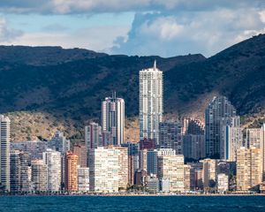 Preview wallpaper buildings, houses, mountains, sea, embankment, city