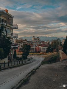 Preview wallpaper buildings, houses, road, mountains, city