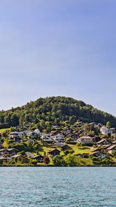 Preview wallpaper buildings, houses, trees, hills, sea, sky