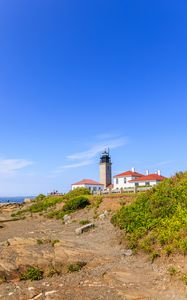 Preview wallpaper buildings, lighthouse, slope, grass, sky