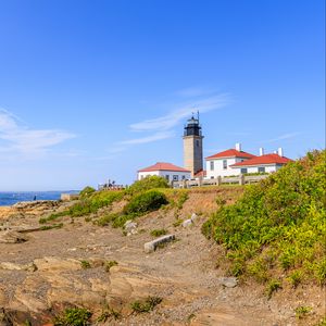 Preview wallpaper buildings, lighthouse, slope, grass, sky