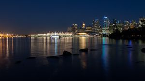 Preview wallpaper buildings, lights, river, reflection, stones, night, city