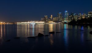 Preview wallpaper buildings, lights, river, reflection, stones, night, city