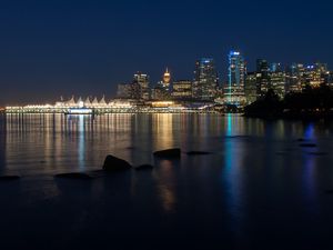 Preview wallpaper buildings, lights, river, reflection, stones, night, city