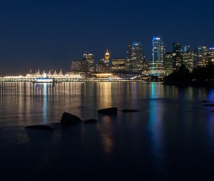 Preview wallpaper buildings, lights, river, reflection, stones, night, city