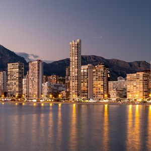 Preview wallpaper buildings, lights, sea, mountains, city, twilight