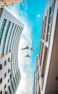 Preview wallpaper buildings, plane, sky, clouds, bottom view