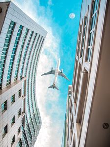 Preview wallpaper buildings, plane, sky, clouds, bottom view