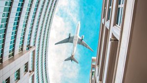 Preview wallpaper buildings, plane, sky, clouds, bottom view