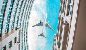 Preview wallpaper buildings, plane, sky, clouds, bottom view