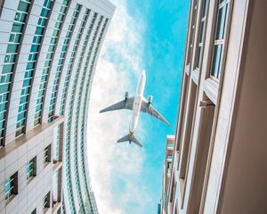 Preview wallpaper buildings, plane, sky, clouds, bottom view