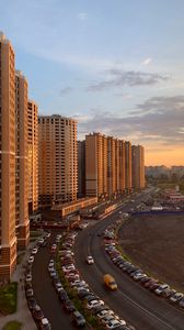 Preview wallpaper buildings, road, cars, evening