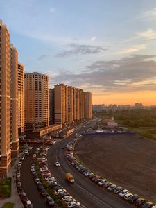 Preview wallpaper buildings, road, cars, evening