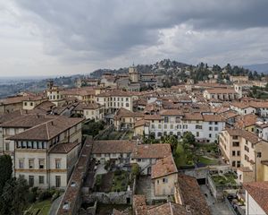 Preview wallpaper buildings, roofs, city, architecture, clouds