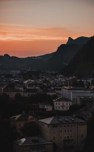 Preview wallpaper buildings, roofs, city, hill, sunset