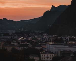 Preview wallpaper buildings, roofs, city, hill, sunset