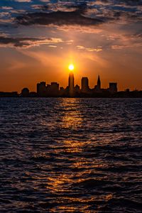 Preview wallpaper buildings, silhouettes, sea, sun, sunset, dark