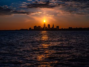 Preview wallpaper buildings, silhouettes, sea, sun, sunset, dark