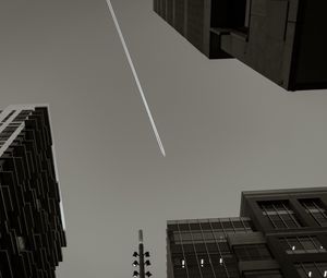 Preview wallpaper buildings, sky, plane, trail, black and white