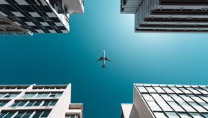 Preview wallpaper buildings, sky, plane, bottom view