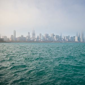 Preview wallpaper buildings, skyscrapers, fog, sea, city