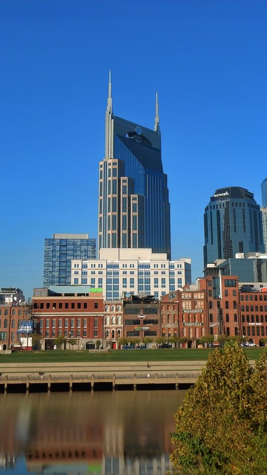 540x960 Wallpaper buildings, spires, reflection, river