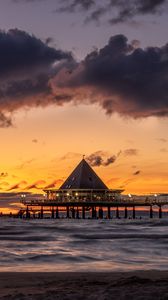 Preview wallpaper bungalow, pier, sunset, sea, sky