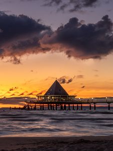 Preview wallpaper bungalow, pier, sunset, sea, sky