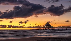 Preview wallpaper bungalow, pier, sunset, sea, sky