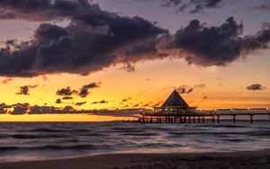 Preview wallpaper bungalow, pier, sunset, sea, sky