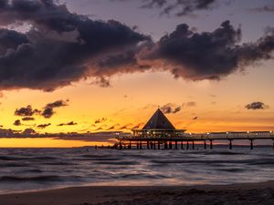 Preview wallpaper bungalow, pier, sunset, sea, sky