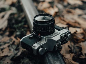 Preview wallpaper camera, gray, rail, fallen leaves